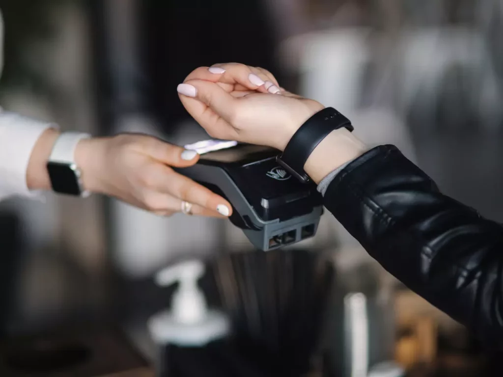 kobieta płacąca zegarkiem z technologią NFC